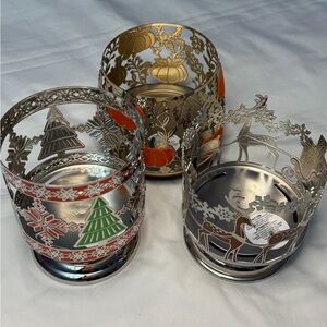 3 Bath & Body Works 3-wick candle holders pumpkin, tree, and reindeer designs.